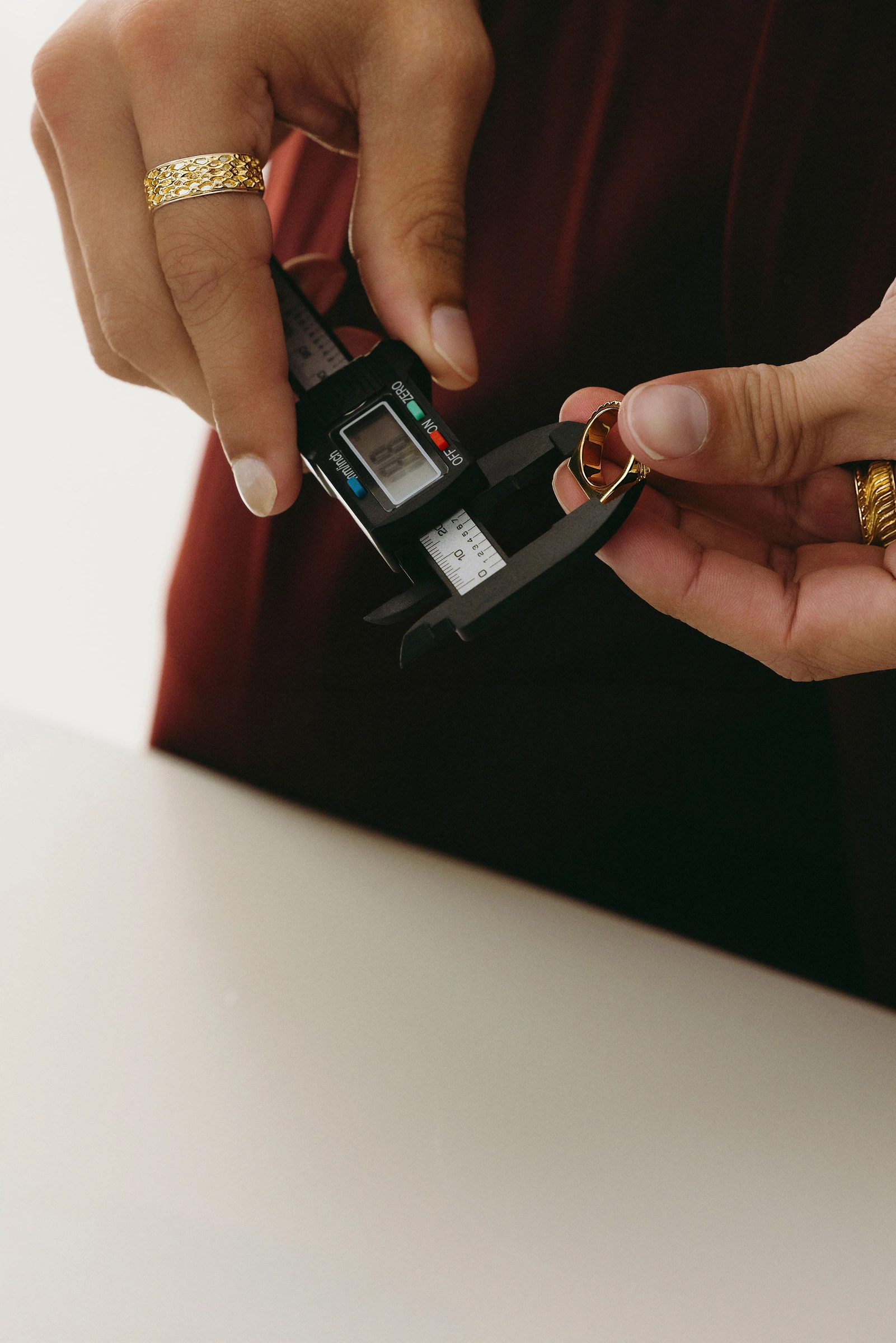 A ring being measured with digital calipers